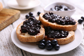 Fresh toast with butter and jam on table close up