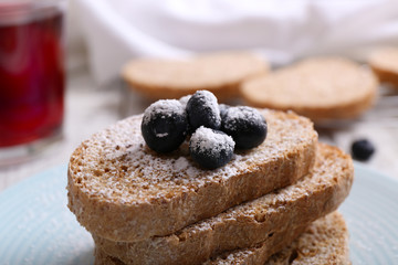 Fresh toast with berries and glass of juice on table close up