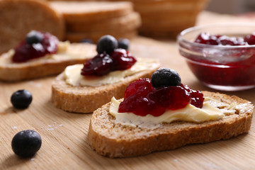 Fresh toast with butter and jam on table close up