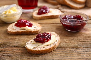 Fresh toast with butter and jam on table close up