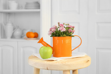 Beautiful flowers in decorative vase on light background