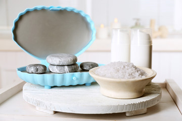Spa stones and spa treatments on light background