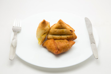 baked and fried keema samosa filled with boiled potato and mutton keema stuffiing - a traditional indian food for breakfast