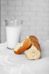 Milk with bread on table in kitchen