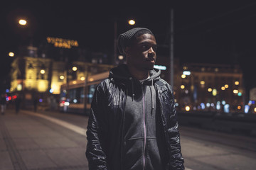 Urban fashion afro man with woolen cap on the streets of Amsterd
