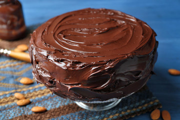 delicious chocolate cake with almond on blue background