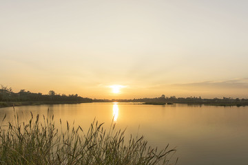 Warm sunrise landscape over the lake