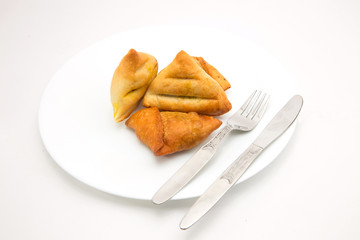 baked and fried keema samosa filled with boiled potato and mutton keema stuffiing - a traditional indian food for breakfast