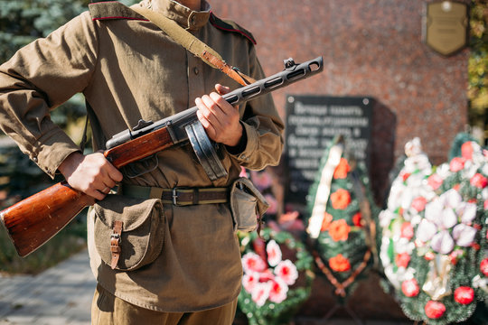 Unidentified reconstructor dressed as Soviet soldier standing on