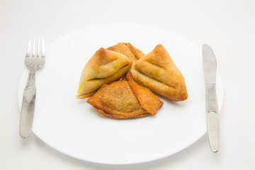 baked and fried keema samosa filled with boiled potato and mutton keema stuffiing - a traditional indian food for breakfast