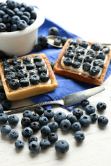 Gourmet fresh blueberry tarts on table