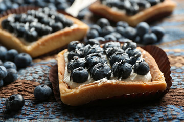 Gourmet fresh blueberry tarts on napkin, close up