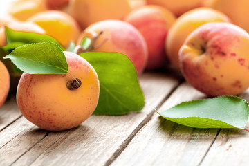 Apricot. Organic fruits with leaf on wooden background