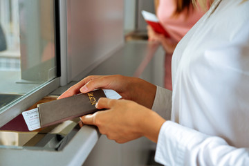 Obraz premium Woman buying tickets with passport at box office