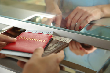 Woman buying tickets with passports at box office