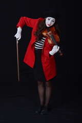 the girl is MIME playing the violin