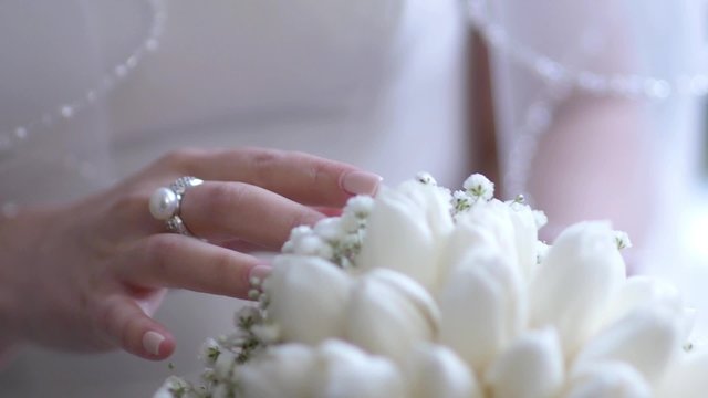 bride adjusts her bouquet