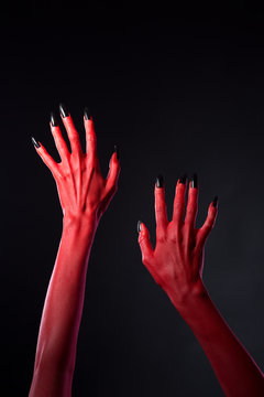 Red devilish hands with black nails, body-art