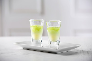Shot glass with jelly on light background