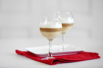 Wine glass with jelly on light background