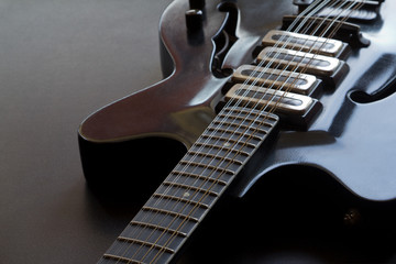 Black electric guitar lying on the table