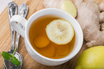 Ginger tea with lemon on a wooden table