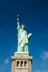 Fototapeta na wymiar Statue of Liberty on blue clear sky, New York City, USA