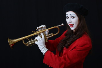 brunette MIME playing the trumpet