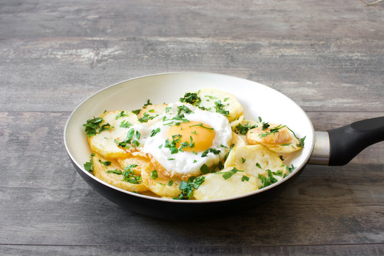 Potatoes and fried egg with parsley