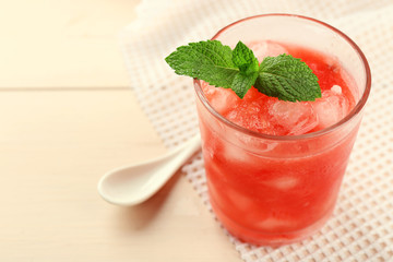 Cold watermelon drinks in glasses, on wooden table background