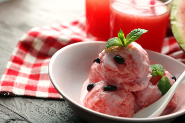Watermelon ice cream in bowl  on color wooden background