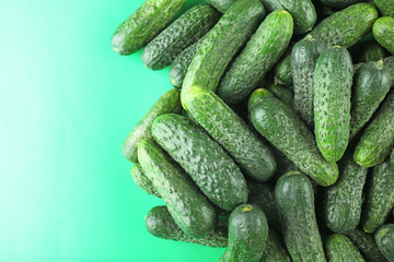 Ripe cucumbers on light green background closeup