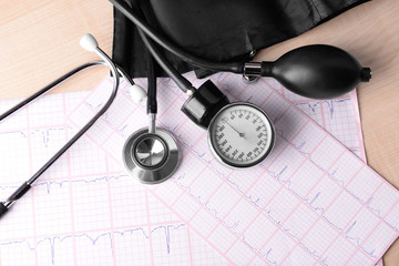 Blood pressure meter, digital tablet and stethoscope, on wooden background