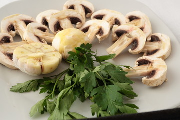 Can of raw mushrooms with garlic and parsley.