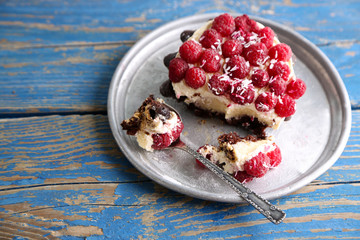 Sweet cake with raspberries on wooden table background