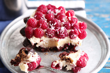 Sweet cake with raspberries on wooden table background