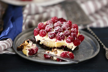 Sweet cake with raspberries on color wooden background