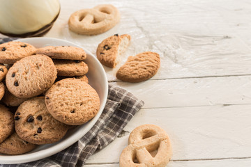 Close up cookies and glass of milk on wooden table - Vintage Sty
