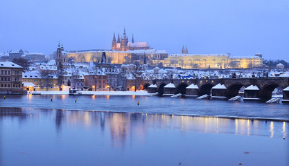 Evening romantic colorful snowy Prague gothic Castle with Charles Bridge, Czech Republic