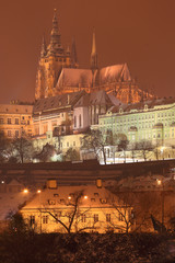 Night colorful romantic snowy Prague gothic Castle above River Vltava, Czech republic
