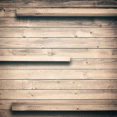 Old brown empty shelf on wooden wall