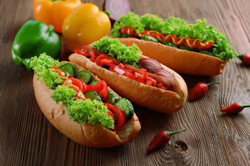 Hot dogs on wooden background closeup