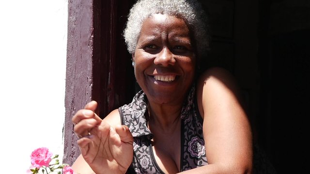 Brazilian Woman Smiles in a Window in a Typical House in Ouro Preto, Minas Gerais, Brazil