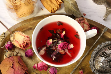 Hot rose tea on metal tray