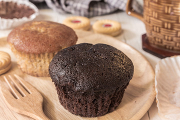 Cupcakes with cup coffee  on a wooden table background