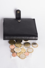 Coins  at black wallet  on white background 