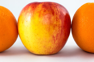 Horizontal line of red apples with half orange.