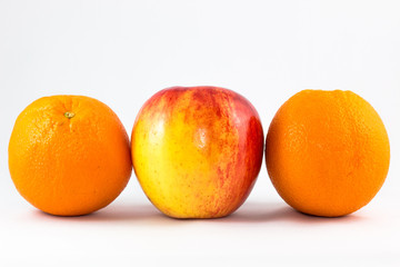 Horizontal line of red apples with two orange.