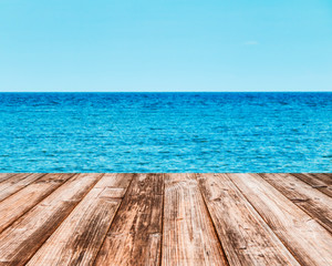 Fototapeta premium Coconut plank under image of peaceful sea with clear sky.