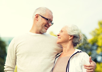 senior couple hugging in city park